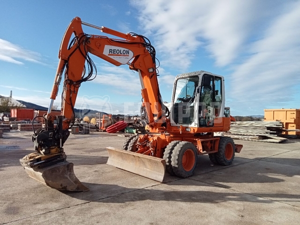 Picture of the Takeuchi TB 295 W with Rototilt and 3 excavator buckets